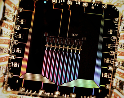 Photograph of a quantum-computing device showing the nine superconducting qubits