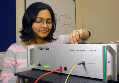 Photo of a Toshiba researcher with quantum-cryptography equipment